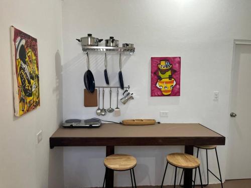 a kitchen with a counter with two stools and a counter top at Ache Pa Ti I Isabela in Isabela
