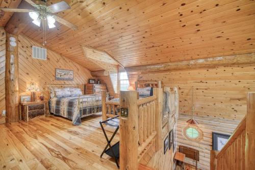 a log cabin bedroom with a bed and a ceiling fan at Uncle Terry's Cabin in Rigby