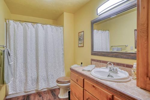 a bathroom with a sink and a toilet and a mirror at Uncle Terry's Cabin in Rigby