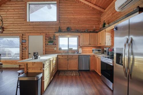 a kitchen with wooden walls and wooden floors at Trout Trap at Henry's Lake in Island Park