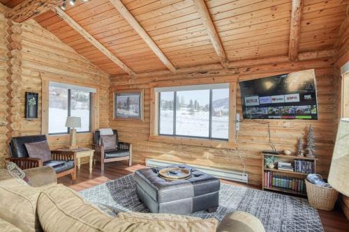 a living room with a couch and a tv at Trout Trap at Henry's Lake in Island Park