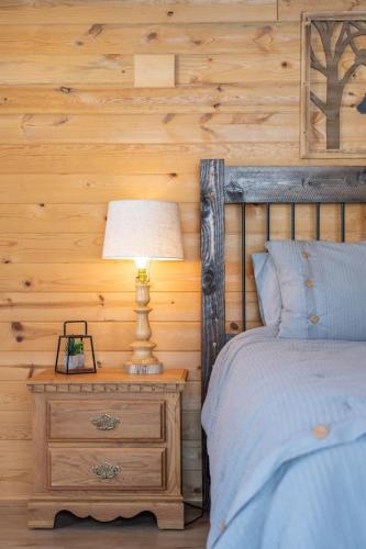a bedroom with a bed and a lamp on a nightstand at Trout Trap at Henry's Lake in Island Park