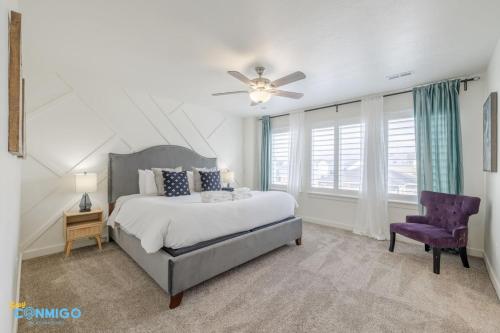 a bedroom with a large bed and a purple chair at Pooley Pad in American Fork