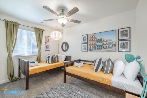 a bedroom with two beds and a ceiling fan at Pooley Pad in American Fork