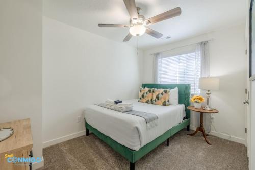 a bedroom with a bed with a ceiling fan at Pooley Pad in American Fork