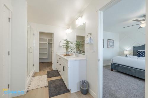 a bathroom with a sink and a bedroom with a bed at Pooley Pad in American Fork