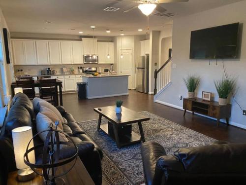 a living room with a couch and a table at Lush 4BR, Large Bckyd, Hot Tub (Tal) in Helotes
