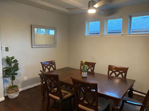 a dining room with a wooden table and chairs at Lxry 4 BR Bckyd, Pool, Hot Tub near attrctns (Tal.) in Helotes