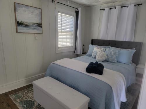 a bedroom with a bed with a pair of shoes on it at Pirates fishing cottage in Cedar Point