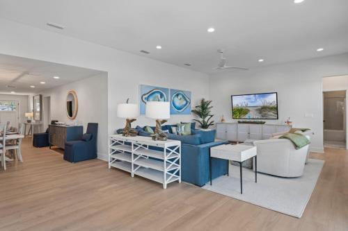 a living room with a blue couch and a table at Taj Duval, Sleeps 14, Pool, Lux in Jacksonville Beach