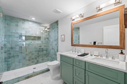 a bathroom with a sink and a shower and a mirror at Taj Duval, Sleeps 14, Pool, Lux in Jacksonville Beach