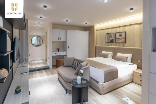 a hotel room with a bed and a couch at Homztality Elbatal Mohandeseen in Cairo