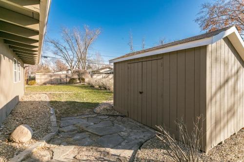 a brown garage next to a house at Mid-Century Style And Class In Quiet NE Location in Cedar Rapids