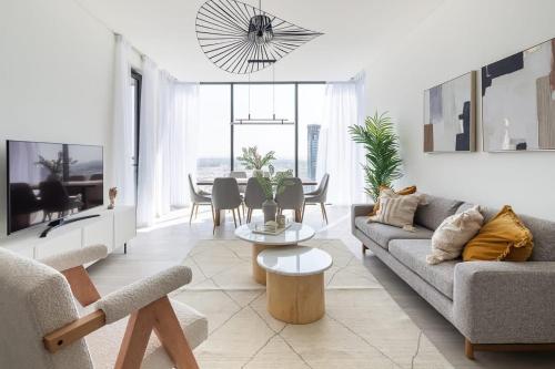 a living room with a couch and a table at Frank Porter - One Park Avenue in Dubai