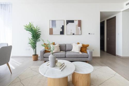 a living room with a couch and a table at Frank Porter - One Park Avenue in Dubai