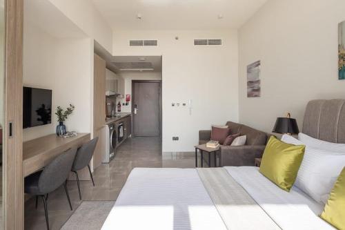 a bedroom with a bed and a living room at Frank Porter - Majestique 1 in Dubai