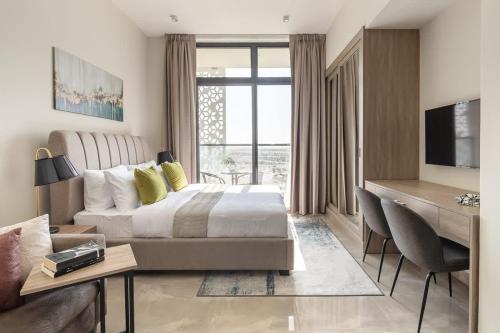 a hotel room with a bed and a desk and a desk at Frank Porter - Majestique 1 in Dubai