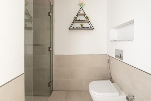 a bathroom with a toilet and a shower at Frank Porter - Lamtara 2 in Dubai