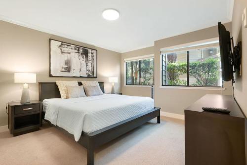 a bedroom with a bed and a television in it at 115 Modern and Serene Min to Downtown in Bellevue