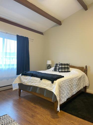 a bedroom with a bed and a window at Fun on Moosehead Lake in Greenville Junction