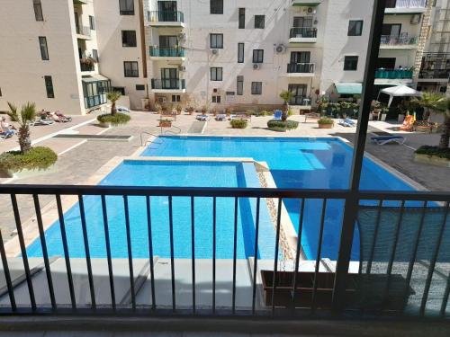 a view of a swimming pool from the balcony of a apartment at Cosy 4 Bedroom Apt with use of Pool in St Paul's Bay