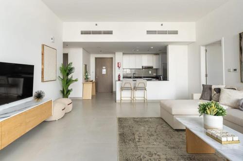 a living room with a couch and a table at Frank Porter - Pulse C2 in Dubai