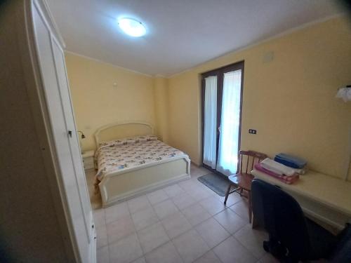 a bedroom with a bed and a window at B&B A CASA DI MARIO in San Severino Lucano