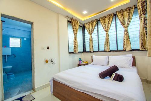 a bedroom with a large bed and a bathroom at Silver leaf Villa in Lonavala