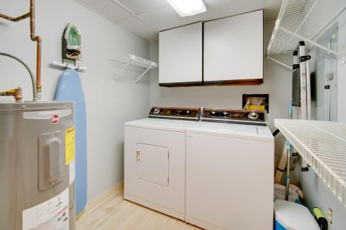 a kitchen with a stove and a washer and dryer at Beautiful Brigantine Condo with Patio and Beach Access in Brigantine
