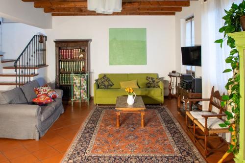 a living room with a couch and a table at Dimora Altana in Brescia