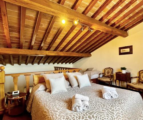 a bedroom with a large bed with towels on it at Residence Internazionale in Pietrasanta