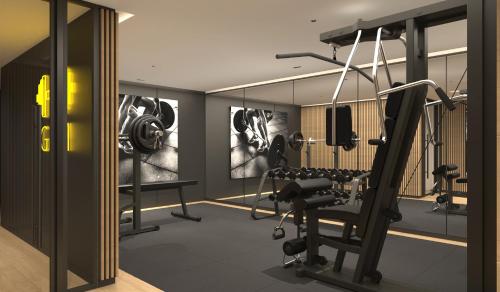 a fitness room with a gym with weights at Divani Escape - Adults Only in Athens