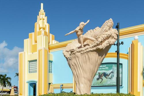 a statue in front of a building with a church at Villa Fiorō -Bold Luxury 2BR - River & Coastal Vibe in Cocoa Beach