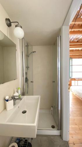 a white bathroom with a shower and a sink at San Liberale sul mare in Trapani