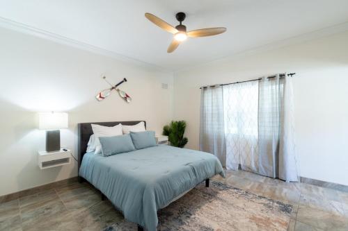 a bedroom with a bed and a ceiling fan at Luxury 2BD 2BTH Condo 5 in Cocoa Beach