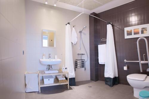 a bathroom with a sink and a toilet at Zarautz SALBIDE APARTMENTS in Zarautz