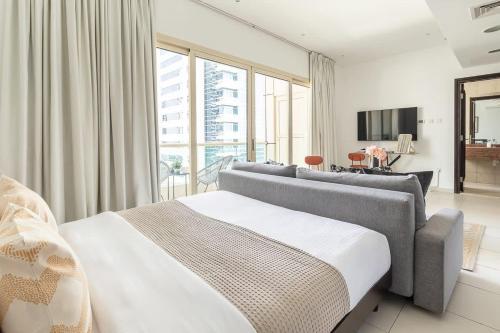 a bedroom with a large bed and a large window at Frank Porter - Royal Oceanic in Dubai