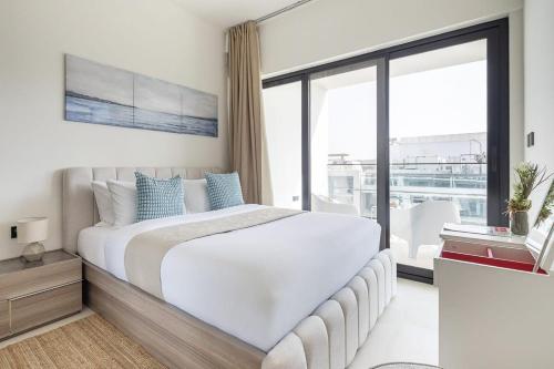 a bedroom with a large bed and a large window at Frank Porter - Binghatti Creek in Dubai