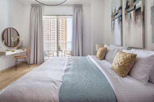 a bedroom with a large bed with a large window at Frank Porter - Beauport in Dubai