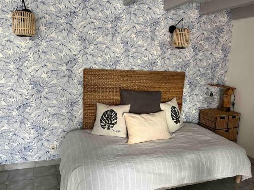 a bedroom with a bed with blue and white wallpaper at Appartement mezzanine spacieux in Jaunay-Marigny