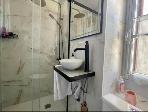 a bathroom with a sink and a glass shower at La Cristina in Berástegui