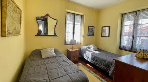 a bedroom with two beds and a mirror at La Cristina in Berástegui