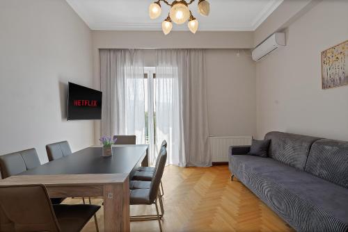 a living room with a table and a couch at Olympic Zeus Apartment in Athens