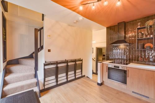 a kitchen with stairs leading up to a stair case at Avenue Apartment in Belfast