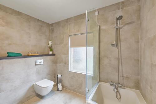 a bathroom with a shower and a toilet and a sink at Avenue Apartment in Belfast
