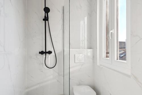 um chuveiro numa casa de banho branca com um WC em Cozy T2 + Cuisine - cœur d'Arpajon em Arpajon