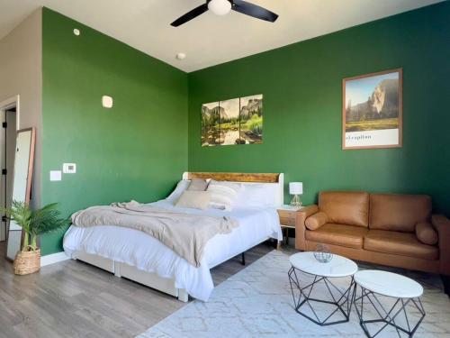 a green bedroom with a bed and a couch at Penthouse Views & Iconic El Capitan Ambiance in Boise