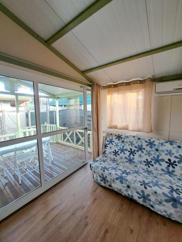 a bedroom with a bed and a balcony at Camping Dal Pino in Marina di Massa