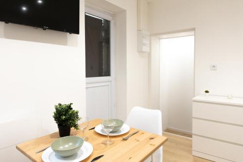 a kitchen and dining room with a wooden table at 1225Location in Cambrai