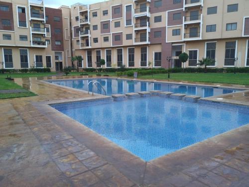 una piscina di fronte a un edificio di Appartement en résidence privée a Marrakech